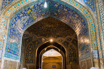 Arches of Historic buildings with persian blue tiles on the wall of Shah Mosque, situated on the...