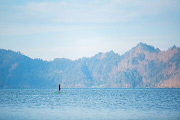 a man on the lake ride a sup board. high quality photo