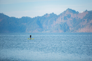 a man on the lake ride a sup board. high quality photo