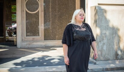  Beautiful woman on a walk in the city. Spring - summer time. A nice middle aged plus size woman at the street. Citizen lifestyle