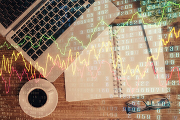 Fototapeta na wymiar Financial market graph and top view computer on the desktop background. Double exposure. Investment concept.