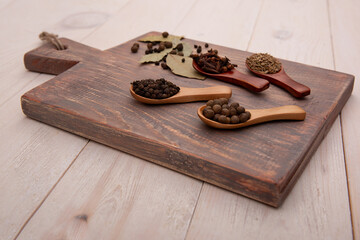 Vintage kitchen utensils and spices on wooden spoon over cutting board. Cooking concept. Top view.
