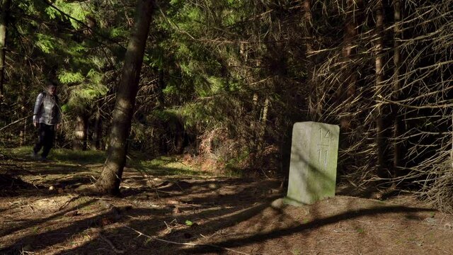 Thurst in the woods near the old border pillar of the Czech-Polish border. Travel concept. Carpathian mountain range. Ukraine. 4K