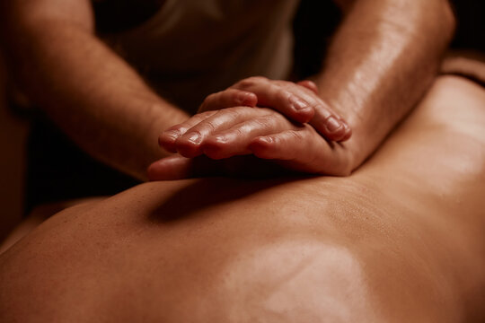 Girl getting back massage. Spa salon