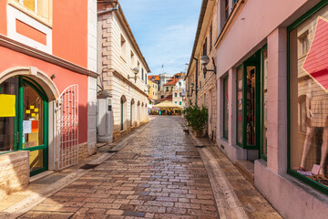 Fototapeta na wymiar Narrow traditional European Street near the Center square, clock-tower and the old town gate of Herceg Novi, Montenegro