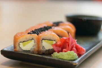 Rolls with Philadelphia cheese and salmon on a tray. Soft selective focus. Blur