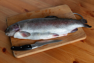 trout lying on a cutting board in the kitchen
