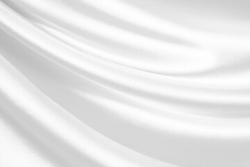 White abstract background. White satin silk texture background. Beautiful soft wavy folds on the fabric. White elegant background.