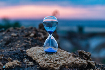 Hourglass on sunset background. Time Concept.