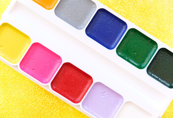Selective focus to  palette of watercolor paint supplies