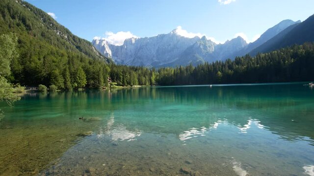 reflection on Fusine Lake, a beautiful alpine lake at Tarvisio, Friuli Venezia Giulia, Italy