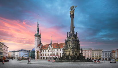 Panorama of Olomouc, Czech Republic at sunset. The Square and the Holy Trinity Column enlisted in the Unesco world heritage list and Astronomical clock in the building of the Town Hall  - obrazy, fototapety, plakaty