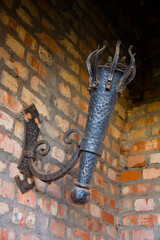 Antique metal torch holder on the wall.