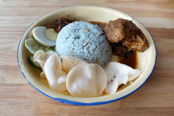 Nasi Lemak with Sambal and Chicken. Nasi lemak is a Malay fragrant rice dish cooked in coconut milk and pandan leaf. A common dish in Malaysia and considered to be the national dish.