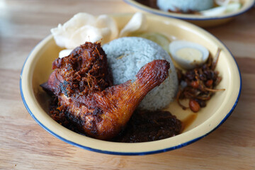 Nasi Lemak with Sambal and Chicken. Nasi lemak is a Malay fragrant rice dish cooked in coconut milk and pandan leaf. A common dish in Malaysia and considered to be the national dish.