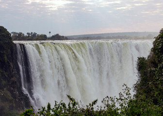 Victoria Falls water flows on the Zambezi River in the morning in July.
