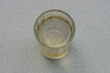 one big old glass of water stands on a gray table