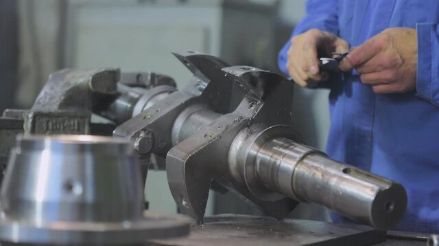 Taking measurements with a caliper. Caliper, Caliper Measurements. A man makes measurements with a caliper.