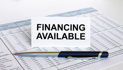 Text Financial Available on white card with blue metal pen on financial table