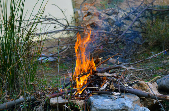 A fire burning outside on a picnic
