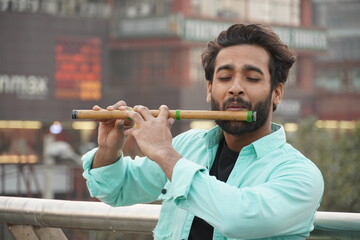 Indian man playing bansuri Indian Bamboo Flute © FireFXStudio