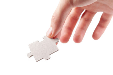 Hand holding a single blank empty jigsaw puzzle piece, laying, putting down from above gesture...