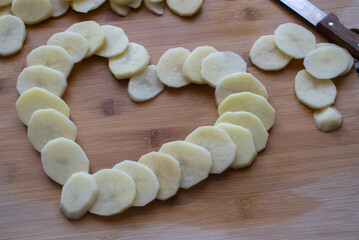 Raw potato. Sliced potatoes on a cutting Board. Raw potatoes cut in circles and a knife on a cutting Board