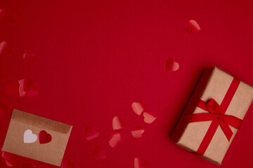 Valentine day composition with copy space. Present or gift box wraped in craft paper with ribbon...