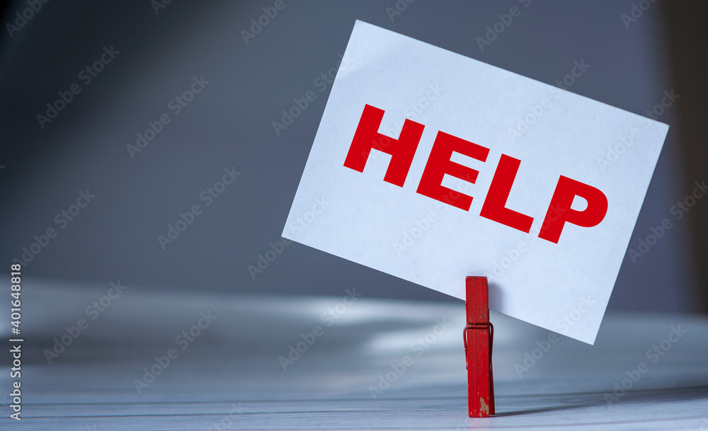 Poster reminder sticky note with clothes pin on table. sticky note with word help. support and assistance c