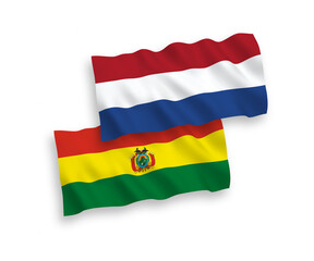 National vector fabric wave flags of Bolivia and Netherlands isolated on white background. 1 to 2 proportion.