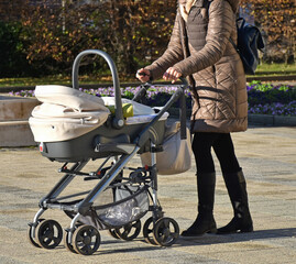 Woman with a baby carriage on the street