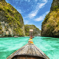 Traditional wooden boat in a picture perfect tropical bay on Koh Phi Phi Island, Thailand, Asia.