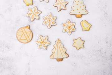Homemade Christmas gingerbread cookies on white background.Cookies of various shapes in sugar...