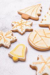 Homemade Christmas gingerbread cookies on white background.Cookies of various shapes in sugar glaze. Snowflake, star, bell, ball, christmas tree close-up.