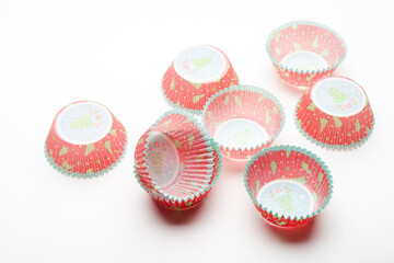 
Paper baking pan for muffins and muffins with christmas pattern on white background, object photography