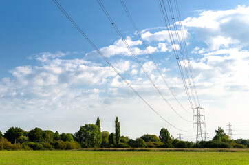 Electricity power lines lines running over a field at Chertsey, England