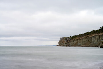 Stone beach with cliff background