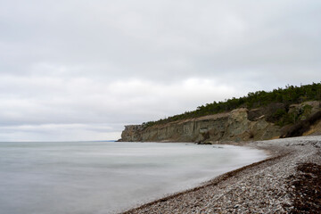 Stone beach with cliff background
