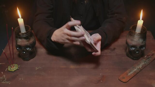 Close up of fortune teller tarot reader shuffle the cards and prepare them to future telling