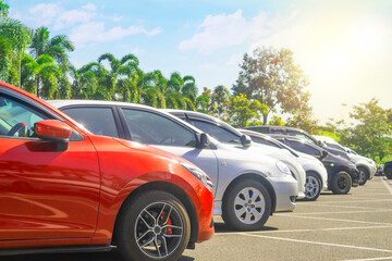 Car parked in asphalt parking lot and one empty space parking  in nature with trees and sky...