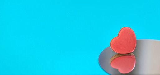 Heart shaped glazed cookies for Valentine's Day with reflection in the mirror presented.
