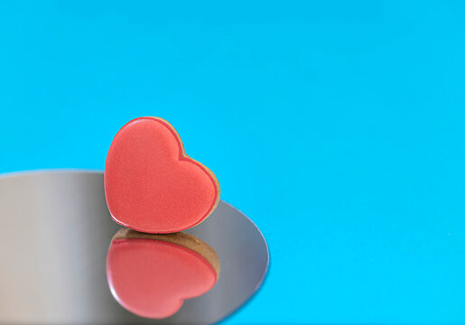 Heart shaped glazed cookies for Valentine's Day with reflection in the mirror presented.