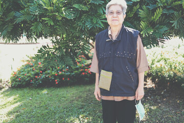 asian old elderly elder woman resting relaxing in garden. senior leisure lifestyle