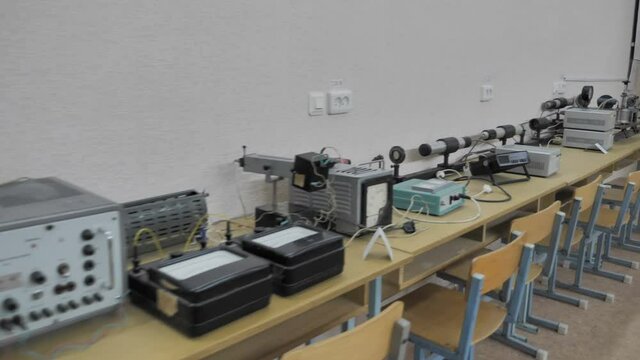 Research equipment and blackboard in the study of physics at college.