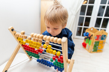 A child with a toy. Boy playing with toy bills