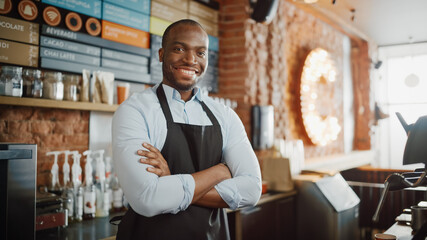 Handsome Black African American Barista with Short Hair and Beard Wearing Apron is Smiling in...