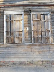 Windows with wooden shutters in old house
