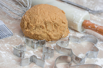 The process of baking cookies at home, closeup on cookie cutter on dough and rolling pin