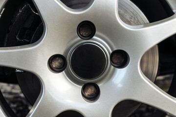 Bolt pattern of aluminum rim. Four hole bolt pattern. Black hub cap.
