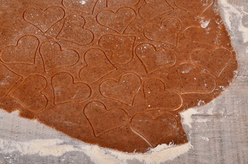 Flat rolled Raw dough for cooking Christmas cookies with ginger heart and other shapes, top view,...